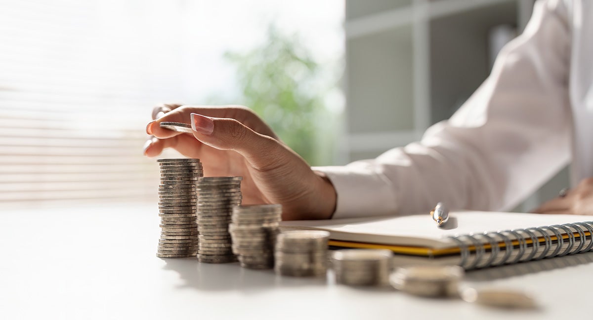 man arranging coins in stack