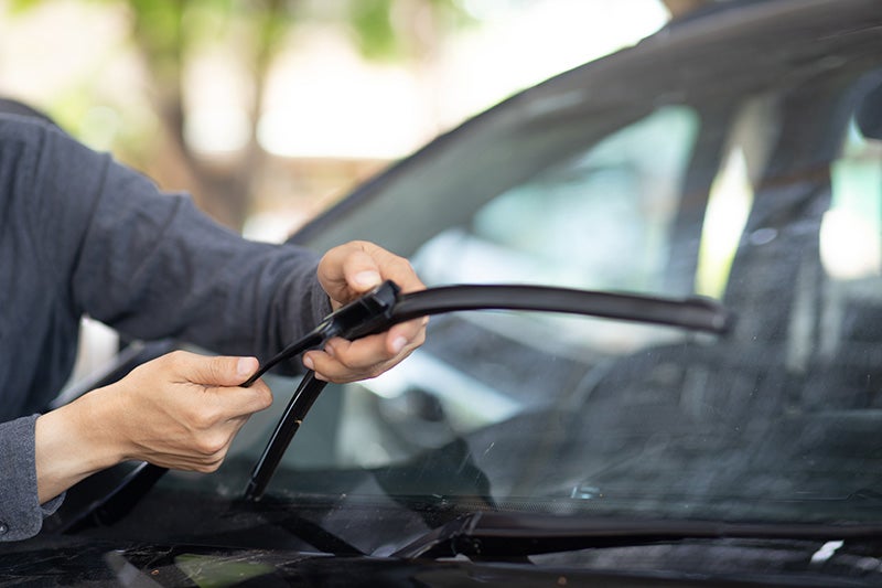 man holding windshield wiper